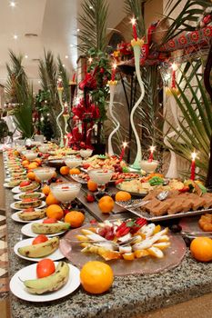 Plates with fruit and confectionery on the table in smorgasbord restaurant