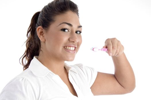 young girl cleaning her teeth on an isolated white background