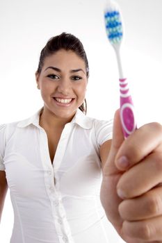 beautiful woman showing her toothbrush with white background