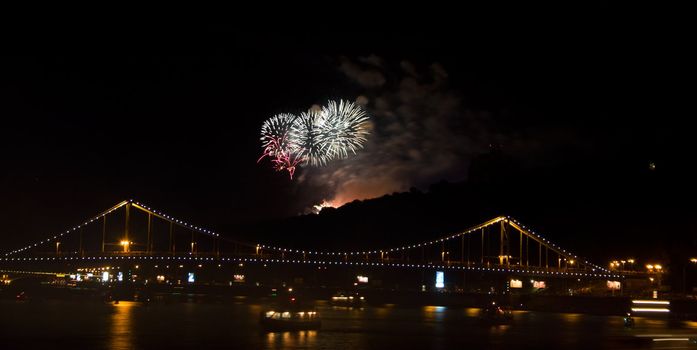 Fireworks in black sky over bridge in Kiev