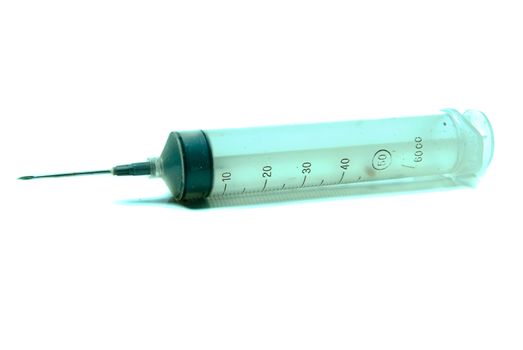 A large dirty syringe isolated against a white background.