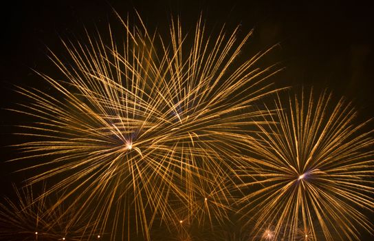 Yellow fireworks stars in black sky