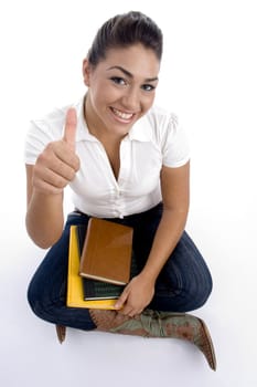pretty teenager girl posing with thumbs up on an isolated white background