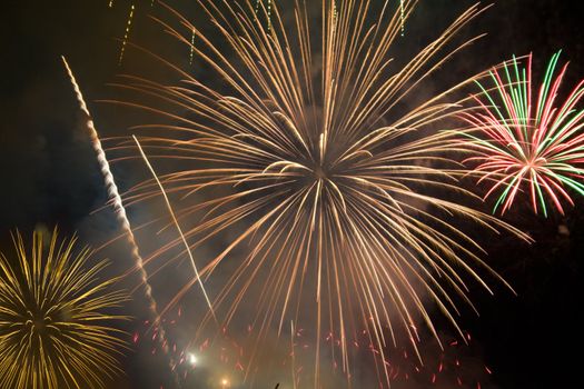 Multicolored fireworks and firecracker in night sky