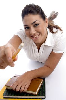 college girl lying with her notebooks on an isolated white background