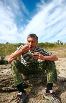 Man eat mush on the nature