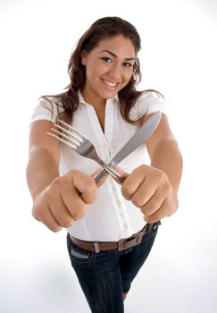 cute teenager showing cutlery on an isolated white background