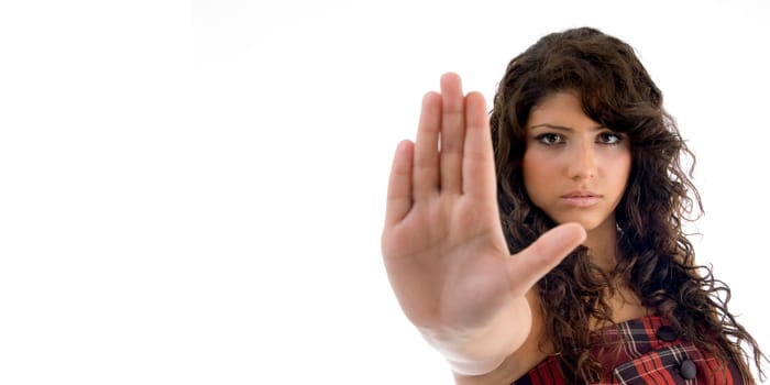 beautiful woman showing stopping gesture on an isolated background