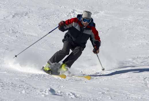 skier moving down on the snow slope
