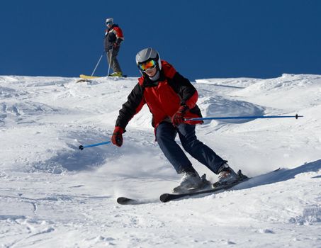 father skier traning his son on snowy mountainside