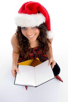 smiling student with christmas hat and books on an isolated background