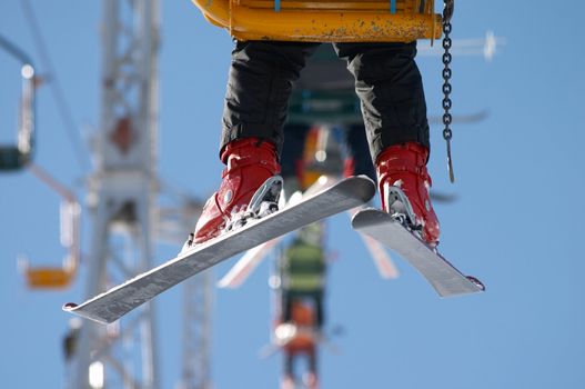 skier moving up on the chair lift