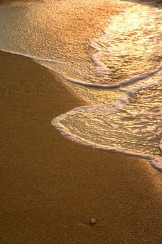 Gentle surf lapping against a golden shore.
