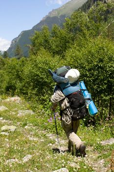 backpacker tourist walking on meadow