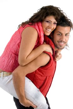 woman riding piggy back on man on an isolated background