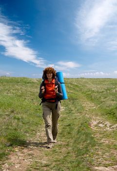 Backpacker girl hiking in spring crimea mountains