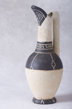 Old-fashioned clay jug with greek ornament