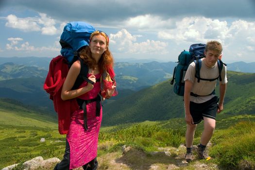 Two travellers with backpack hiking in the Carpathian mountains