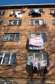 Windows with washed clothes on the ropes