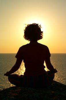 meditation above the sea in time of sunset