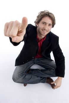 sitting model pointing you against white background