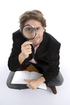 sitting man with diary and lens with white background