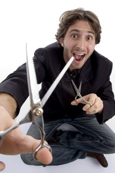 young barber with scissors against white background