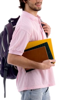 young man holding bag and books on an isolated background