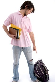 standing student pointing to bag against white background