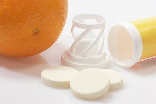 Effervescent tablets with plastic container on yellow background