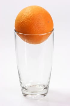 Glass with orange  on bright background