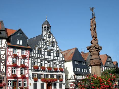 Historic building facades of Butzbach, Germany, with flowering window boxes, timber framing.