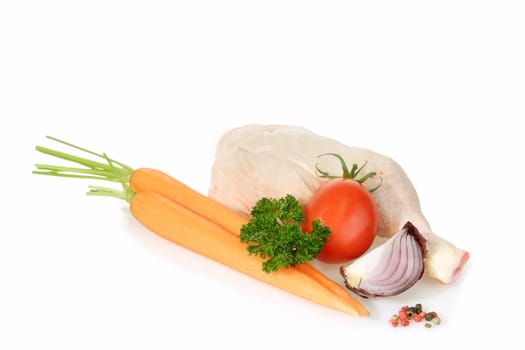 Raw chicken leg with vegetables on bright background