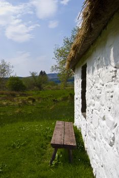 bench in front of a cosy cottage in Scotland