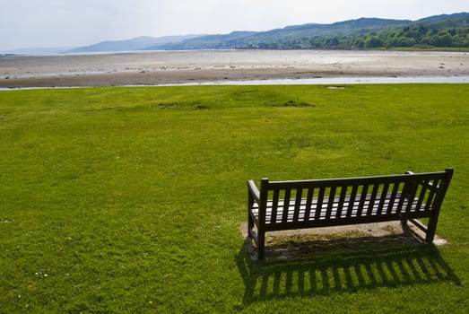 bench overlooking a loch at low tide