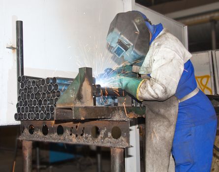 Factory Worker Welding on a production line