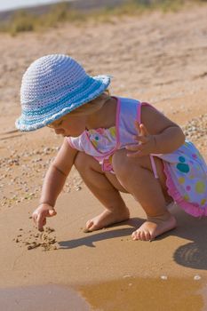 people series: little girl draw on the wet sand