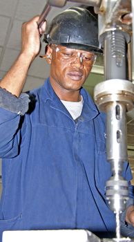 Man drilling with an industrial drill press