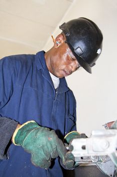 A man grinding a piece of metal