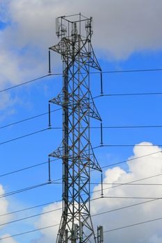 Top of the electricity pylon over cloudscape.
