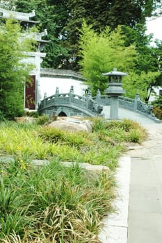 A bridge at Oriental Garden with green surroundings