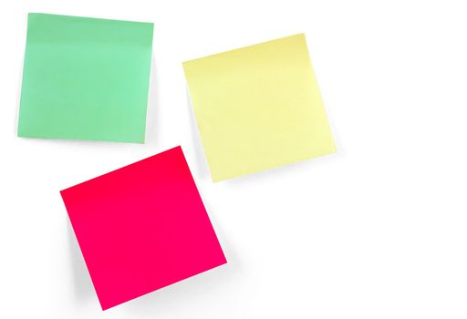 Three multicolor stickers hanging on white wall
