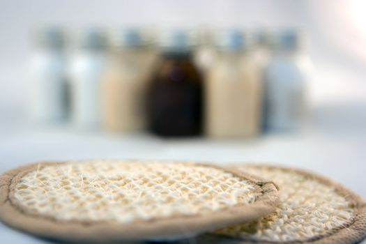 Two sponges and bottles on the background