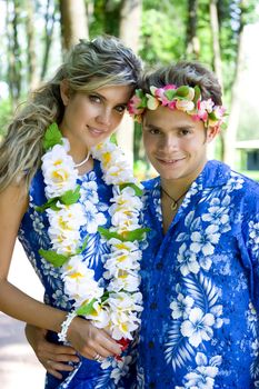 A couple standing with Hawaian flower on their necks