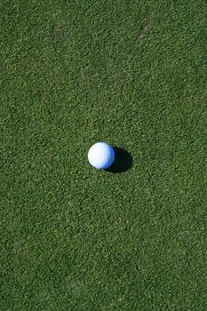 Close up of a golf ball on a golf course.
