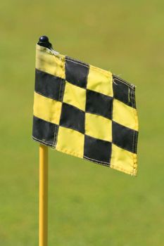 Flag on a green grass golf course.
