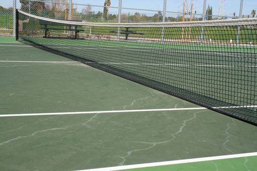 Tennis court during day time in a park.
