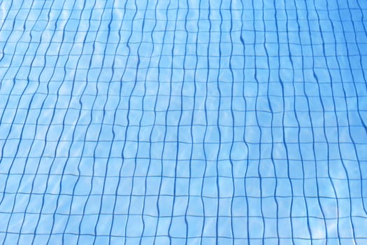 blue water texture at pool with grid sandstone