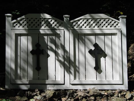 black cross on white wooden doors