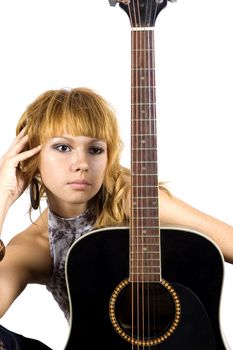 Thoughtful musician. Young, pretty girl - close portrait with black guitar.